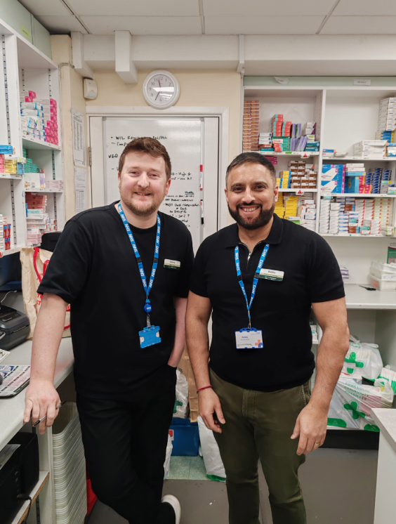 Danny and his employer stood together in their pharmacy